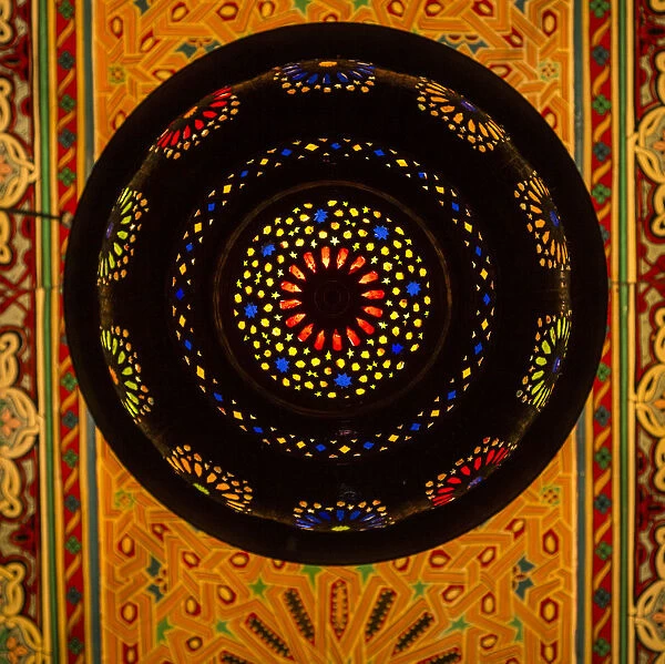 Morocco. A graphic silhouetted detail of a metal Moroccan lamp in a ceiling of a