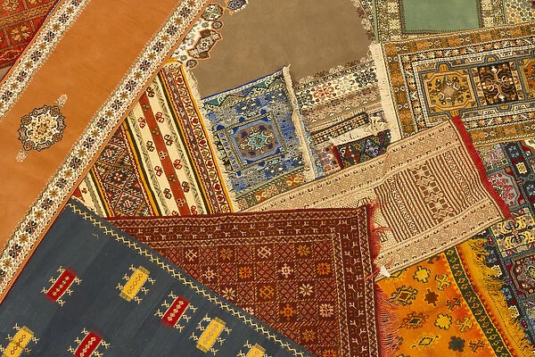 Morocco, Tinerhir. Colorful handmade Berber carpets are displayed for sale in a shop