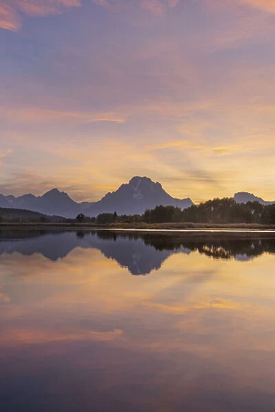 Mount Moran and clouds glowing red and orange at Oxbow Bend, Grand Teton National Park, Wyoming