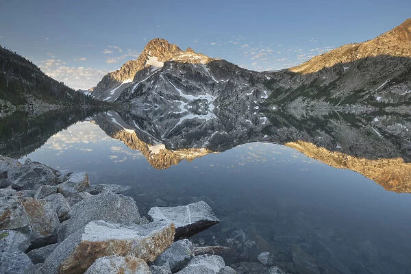 Mount Regan mirrored in still waters of Sawtooth Lake at sunrise, Sawtooth Mountains Wilderness, Idaho