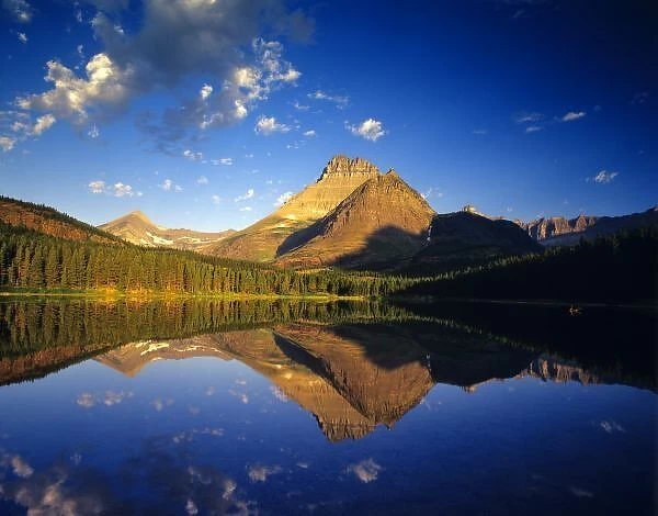Mount Wilbur reflects into calm Fishercap Lake in Glacier National Park in Montana