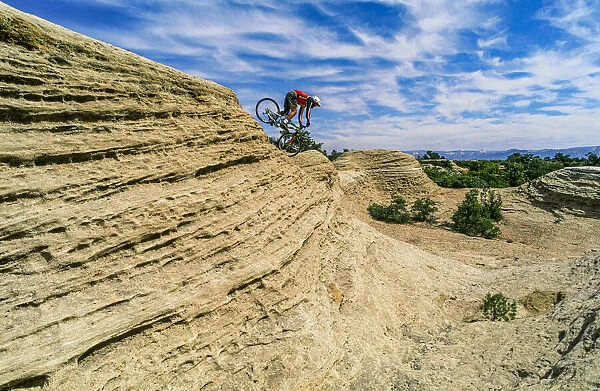 Mountain biker balances courage and danger and attempting to avoid crash on Red Rock