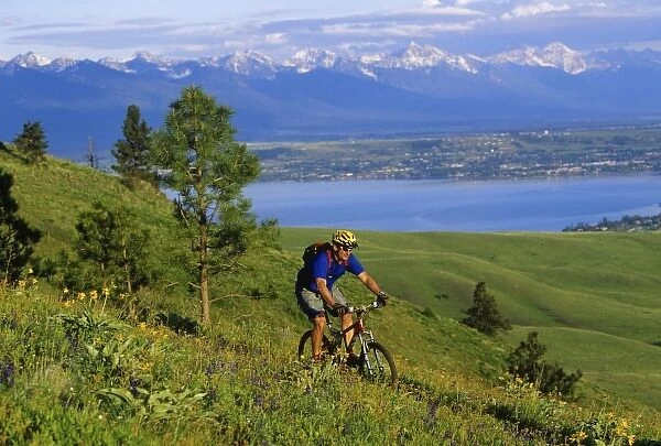 Mountain biker on South Ridge Trail above Flathead Lake and Mission Mountains (MR)