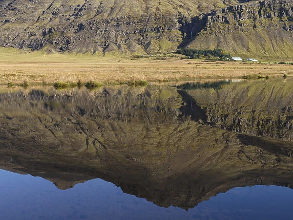 Mountain and homestead reflection in Lake, Iceland