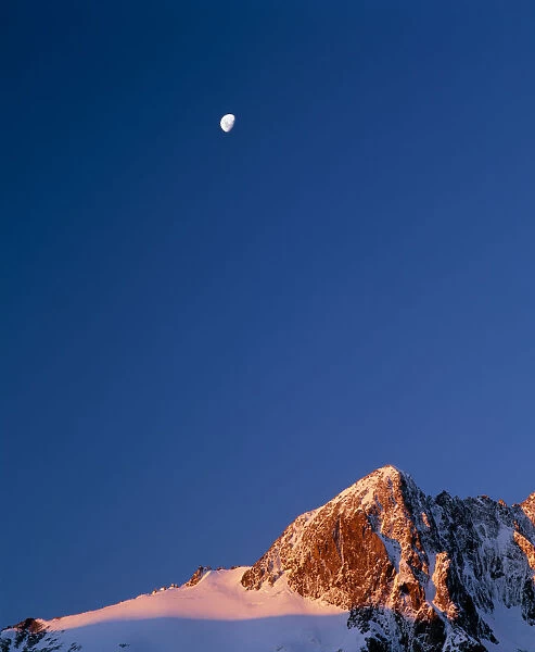 Mt. Crosscut and a rising moon in the evening light, Fjordland Nat l Park on the South Island