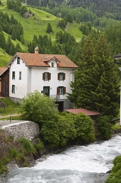 Mulegns, Switzerland. Stream and house in Mulegns
