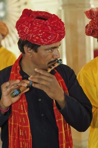Musician playing flute inside Amber Fort, Jaipur, India