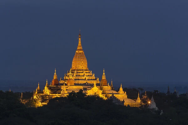 Myabnmar, Bagan. A giant stupa is lit at night on the plains of Bagan