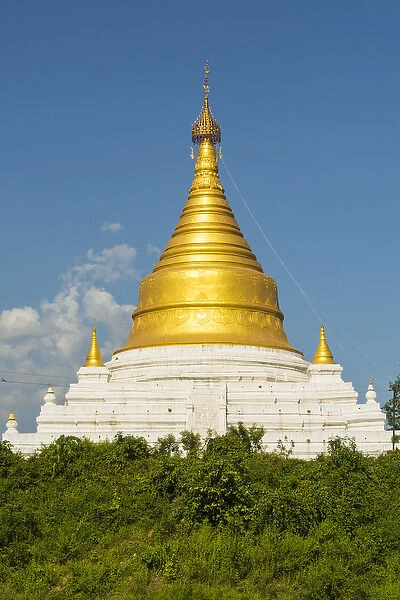 Myanmar. Mandalay. Inwa. Bright golden pagoda in the trees