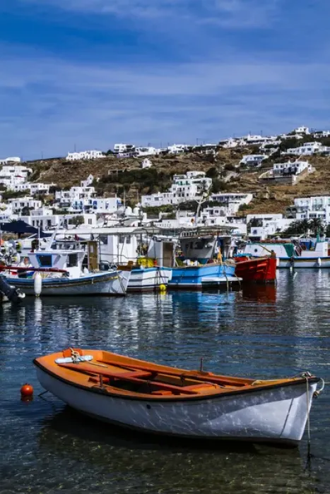 Framed Print : Mykonos, Greece. Orange and white boat floats in the water with other colorful boats Framed Print : Mykonos, Greece. Orange and white boat floats in the water with other colorful boats