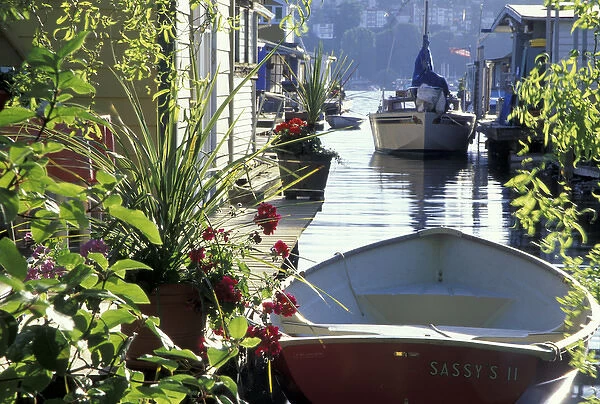 N. A. USA, Washington, Seattle. Rowboat and planters in houseboat community on Lake Union