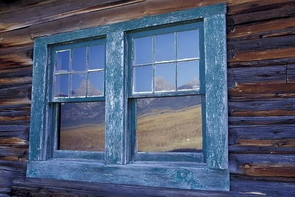 N. A. USA, Wyoming, Grand Teton National Park, Window reflections of Grand Tetons