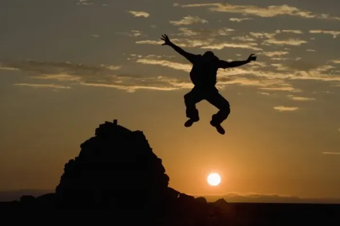 Framed Print : Namibia, Namib Naukluft National Park, Silhouette of man leaping from rock cairn Framed Print : Namibia, Namib Naukluft National Park, Silhouette of man leaping from rock cairn