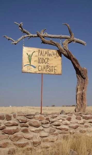 Namibia. Palmwag Lodge sign hung on dead tree