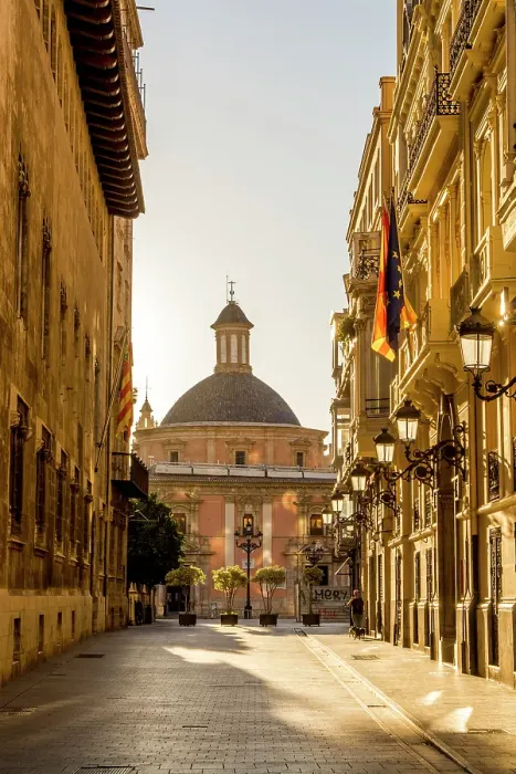 Framed Print : Narrow cobblestone street and Cathedral Dome near Placa de la Mare de Deu, Valencia, Spain
