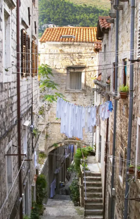 Framed Print : A narrow street leading down with steep steps, clothes lines hanging across the street Framed Print : A narrow street leading down with steep steps, clothes lines hanging across the street