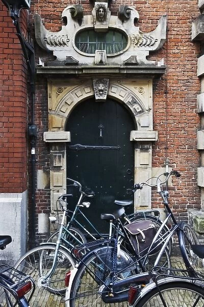 Netherlands, Amsterdam. Bicycles parked in front of building door