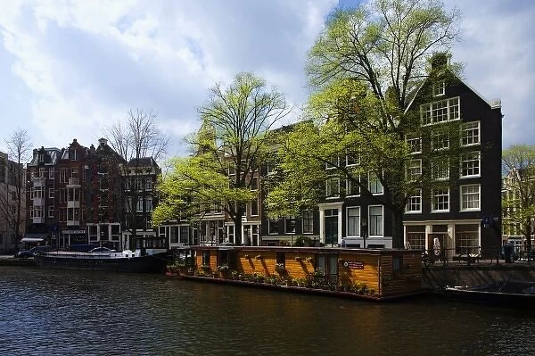 Netherlands, Amsterdam. View of Tulip Museum and buildings lining canal