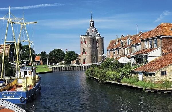 Netherlands, Enkhuizen, Classic Dutch vessels in the canal, Drommedaris Tower in the background
