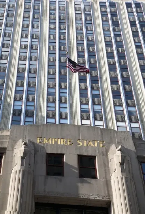 Framed Print : New York, NY, USA - An American flag is flying above the entrance to the Empire State Framed Print : New York, NY, USA - An American flag is flying above the entrance to the Empire State