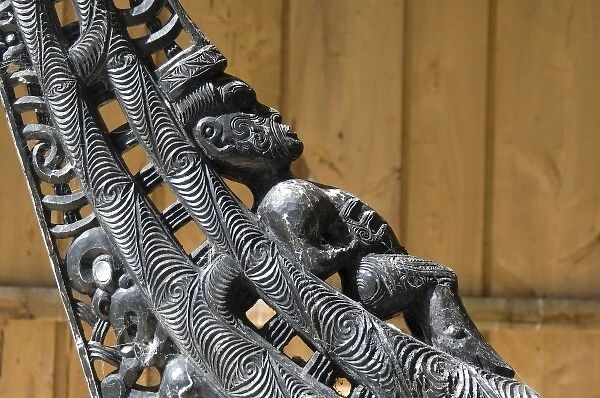 New Zealand, South Island, Oakins Bay. Wood carvings on a traditional Maori canoe