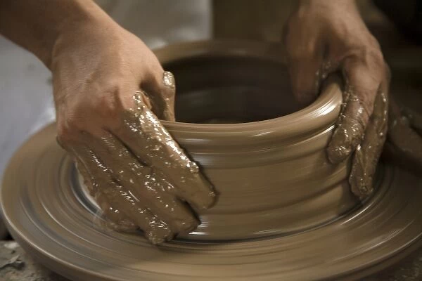 Nicaragua, Catarina. Potters hands creating clay pottery on spinning wheel