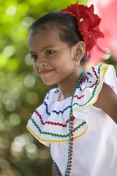 Nicaragua, Granada. Girl in traditional dress dancing in Villa Esperanza barrio. (MR)
