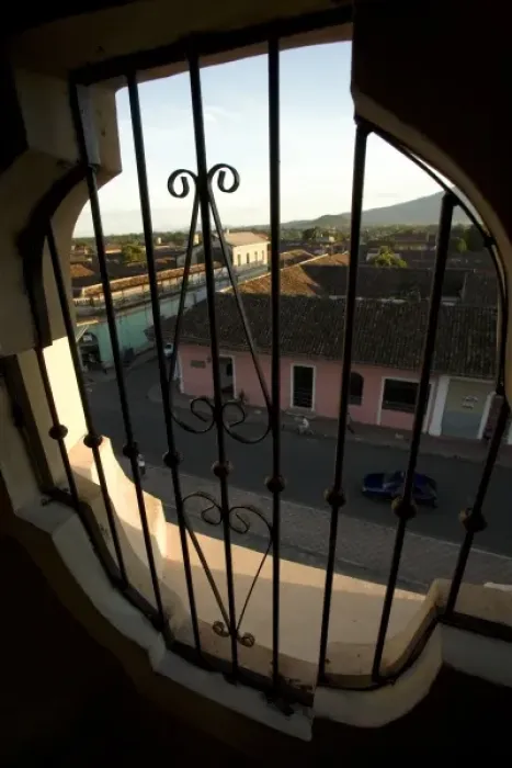 Framed Print : Nicaragua, Granada. Streets with pastel houses, viewed from above through iron grill Framed Print : Nicaragua, Granada. Streets with pastel houses, viewed from above through iron grill