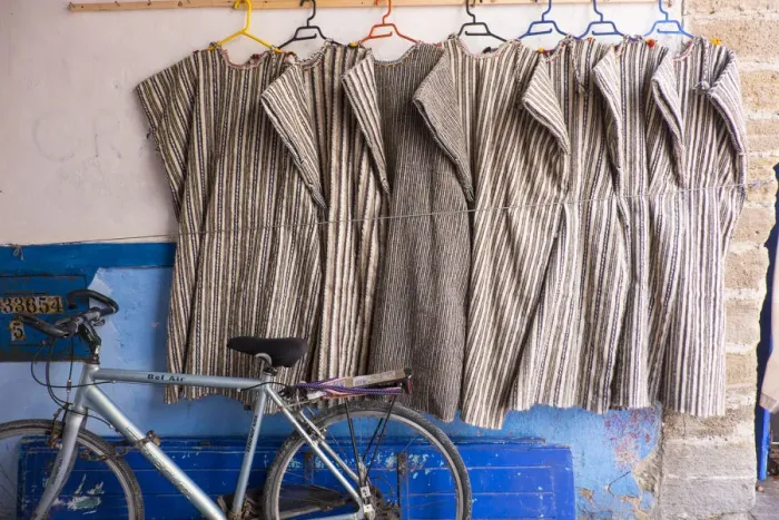 Framed Print : North Africa, Morocco, Essaouira, djeallbas hanging on wall next to bicycle Framed Print : North Africa, Morocco, Essaouira, djeallbas hanging on wall next to bicycle