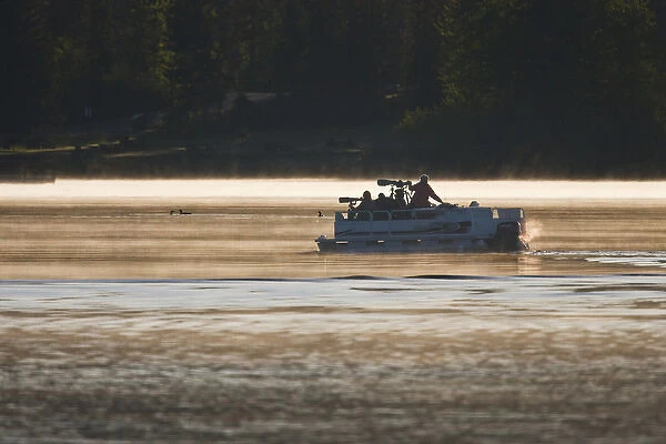 North America, Canada, British Columbia near Kamloops, wildlife photographers on pontoon