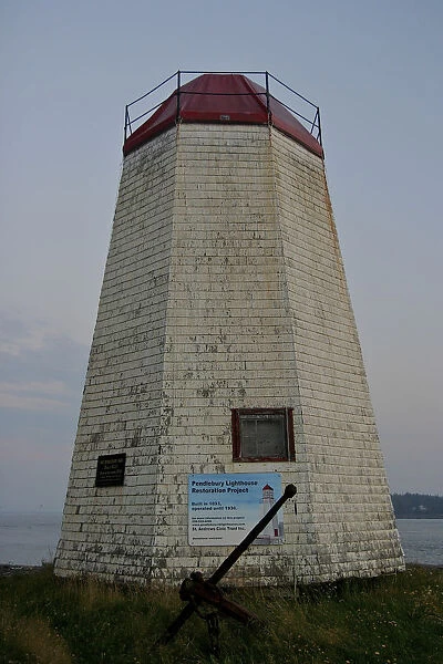 North America, Canada, New Brunswick, St Andrews. A weathered lighthouse on the harbor
