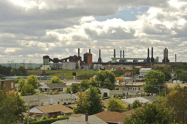 North America, Canada, Quebec, Mauricie. View of an aluminum plant past the roofs