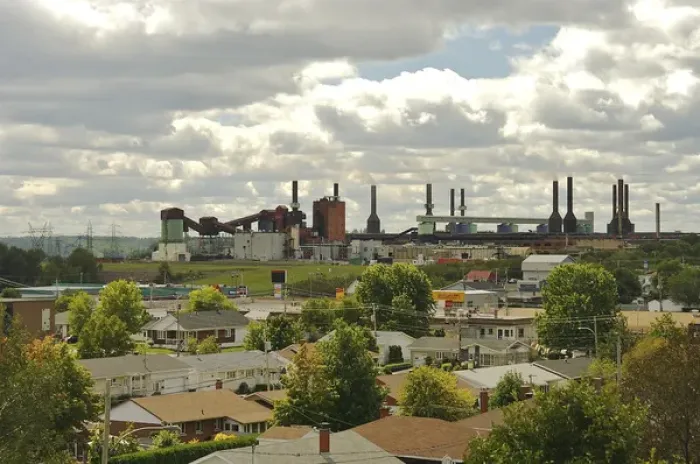 Framed Print : North America, Canada, Quebec, Mauricie. View of an aluminum plant past the roofs
