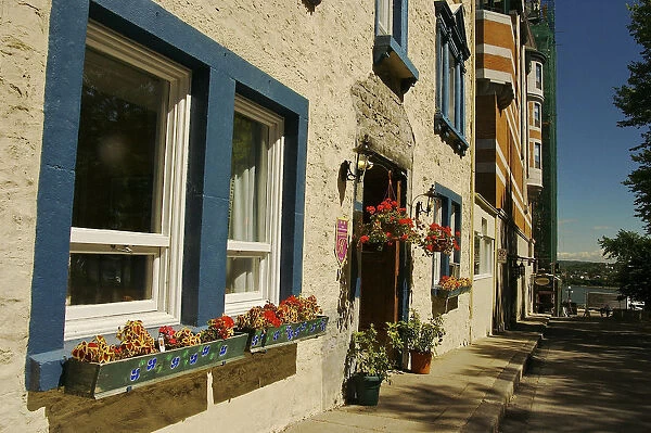 North America, Canada, Quebec, Old Quebec City. Flowers decorate an old stone building