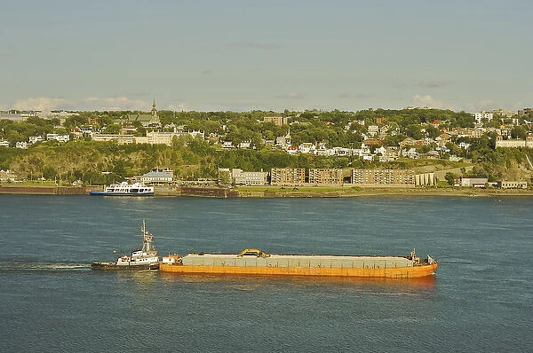 North America, Canada, Quebec, Old Quebec City. View of a barge in the Saint Lawrence River