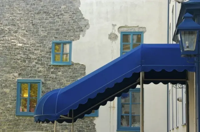 Framed Print : North America, Canada, Quebec, Old Quebec City. Blue awning and trim, and a wall of stucco