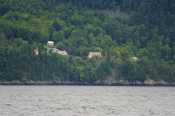 North America, Canada, Quebec, Saguenay. View from the water of houses amongst trees