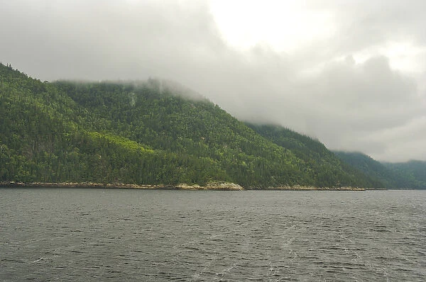 North America, Canada, Quebec, Saguenay. Low clouds over the hills on the banks of