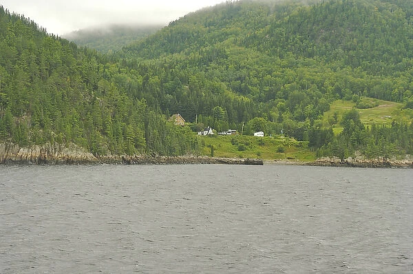 North America, Canada, Quebec, Saguenay. Houses on misty hills near the banks of