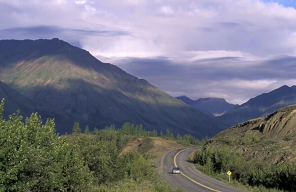 North America, Canada, Yukon, Kluane National Park. Car drives on road near Kluane Lake