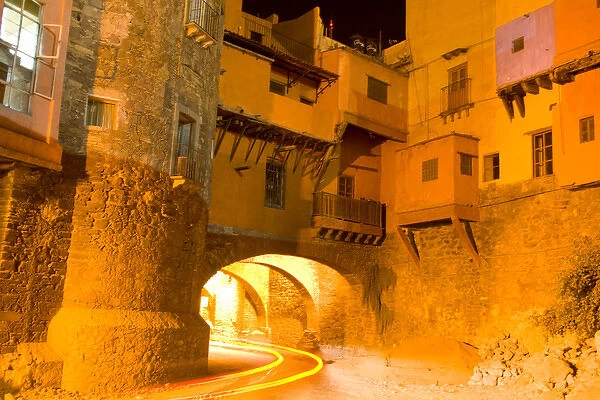 North America, Mexico, Guanajuato. Subterranean street at night with houses built above
