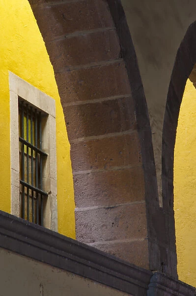 North America, Mexico, Guanajuato Looking up through arched columns against a yellow