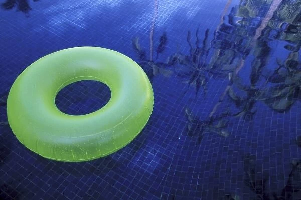 North America, Mexico, Jalisco, Puerto Vallarta. Green innertube in hotel pool