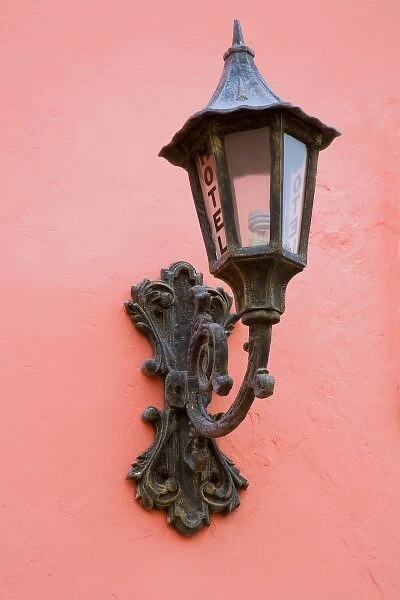 North America, Mexico, Yucatan, Merida. Hotel lamppost on a pink exterior wall