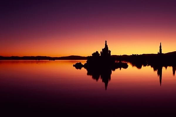 North America, U. S. A. California, Mono Lake, Tufa towers reflect in still Mono Lake