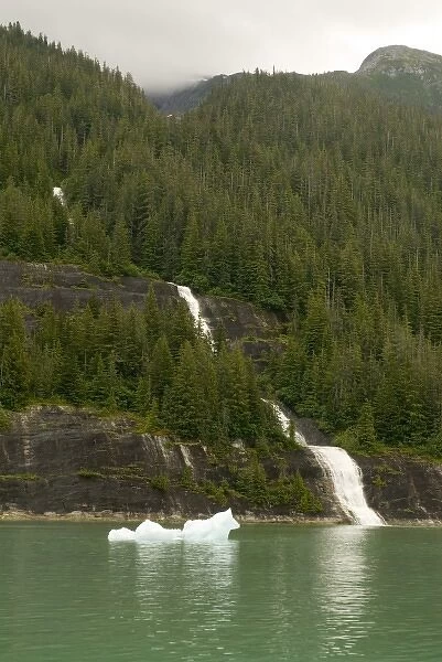 North America, USA, AK, Inside Passage. Waterfall through forest to ocean with ice floe