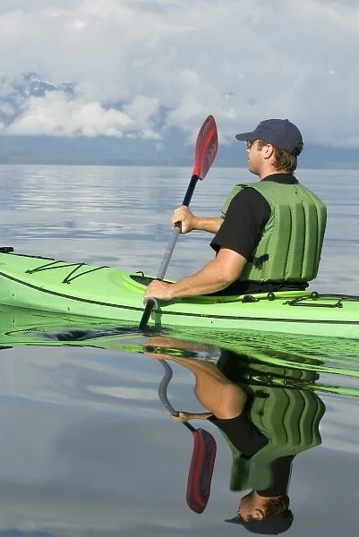 North america, USA, AK, Inside Passage. Kayaker enjoys brilliant calm day (MR)