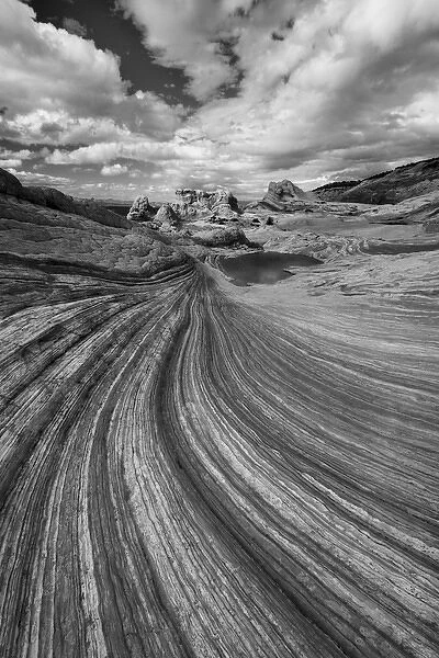 North America, USA, Arizona. Black and white image of clouds, a small pool, and the