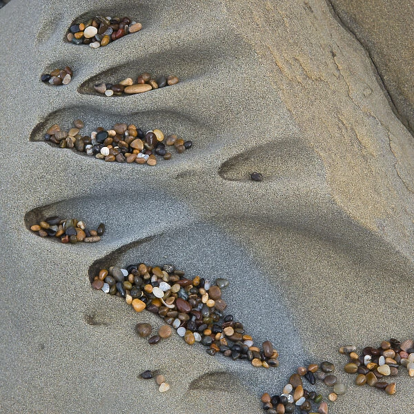 North America, USA, California. Colorful small pebbles deposited in abstract sculpted