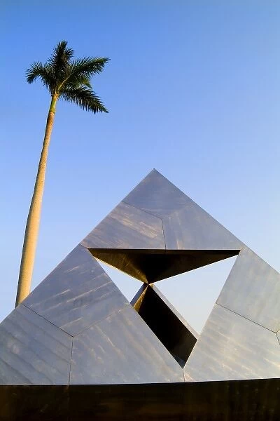 North America, USA, Florida, Palm Beach. Pyramid abstract statue under the palm tree